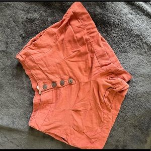 Orange shorts with pockets & button detail